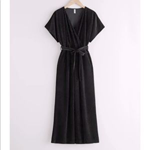 Plissé Pleated Wrap Jumpsuit in black glitter.